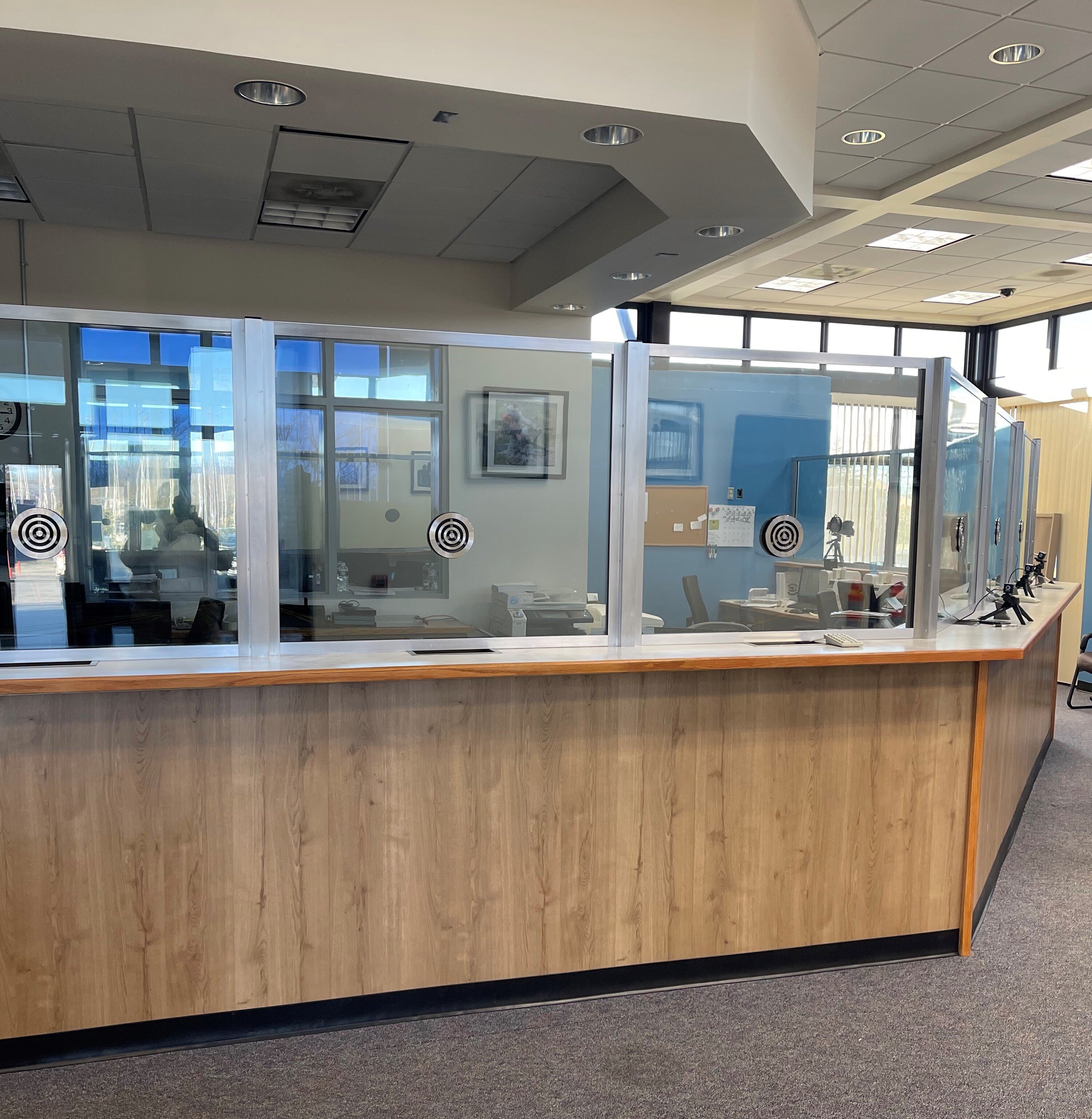 Government reception with ballistic glazing and walk-through detection at the entrance.